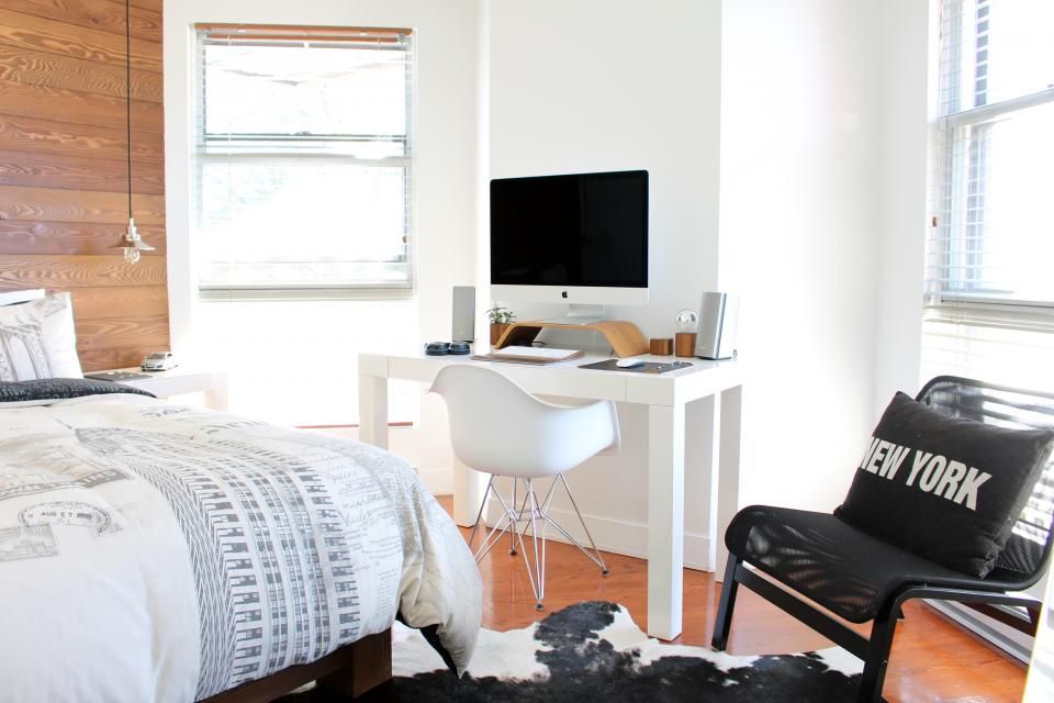 A guest room with a large bed and soft lighting