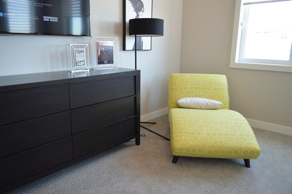 A guest room with two beds and a window